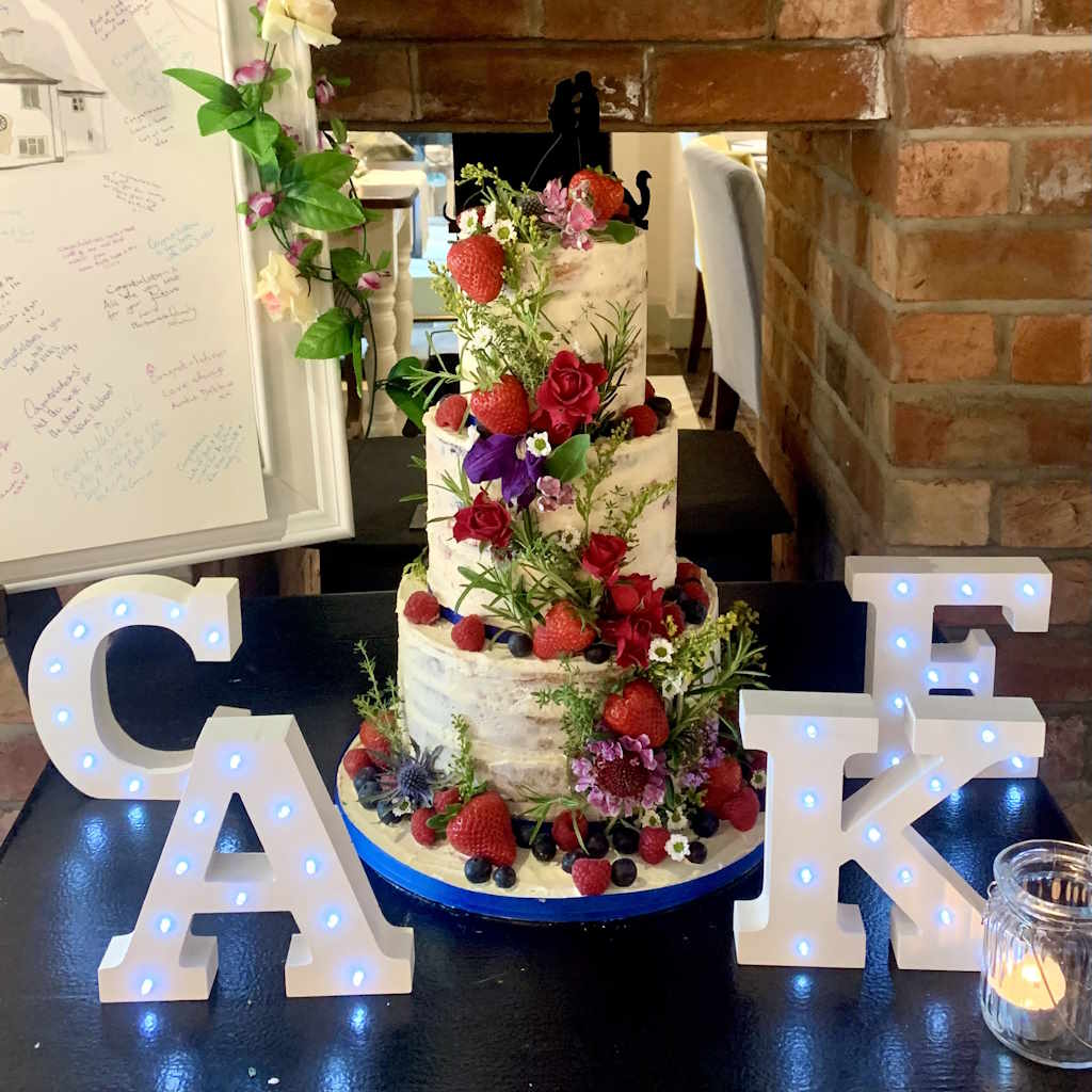 Buttercream wedding cake gluten-free vegan fruit flowers